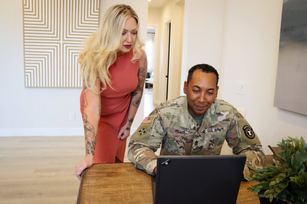 A military relocation professional is helping a uniformed soldier with moving services