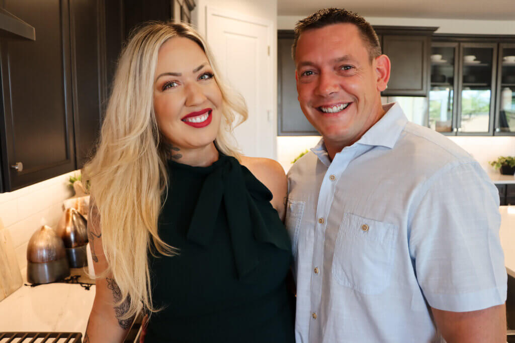 Two military relocation professionals are standing in the kitchen of a new home