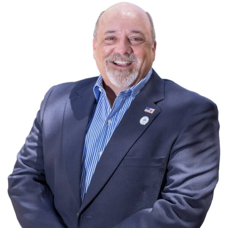 A man is wearing an american flag pin on his blazer and offering home relocation services